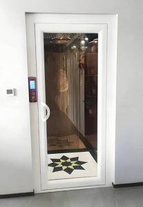 a white landing door install on a home elevator shaft