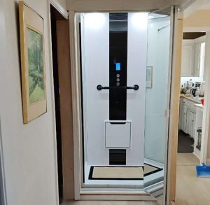 A modern home lift elevator featuring digital controls and a sleek design.