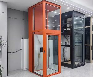 Two modern home lift for elderly, one orange and one black, displayed in an indoor setting.