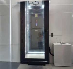 a black home elevator cabin with lights on the top ceiling