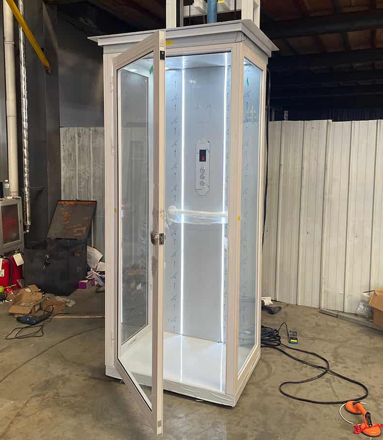 a white home elevator with a swing door opening